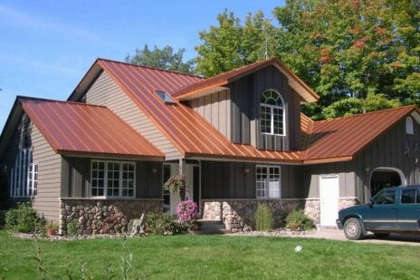 Copper Metal Roof With A Cream Siding 